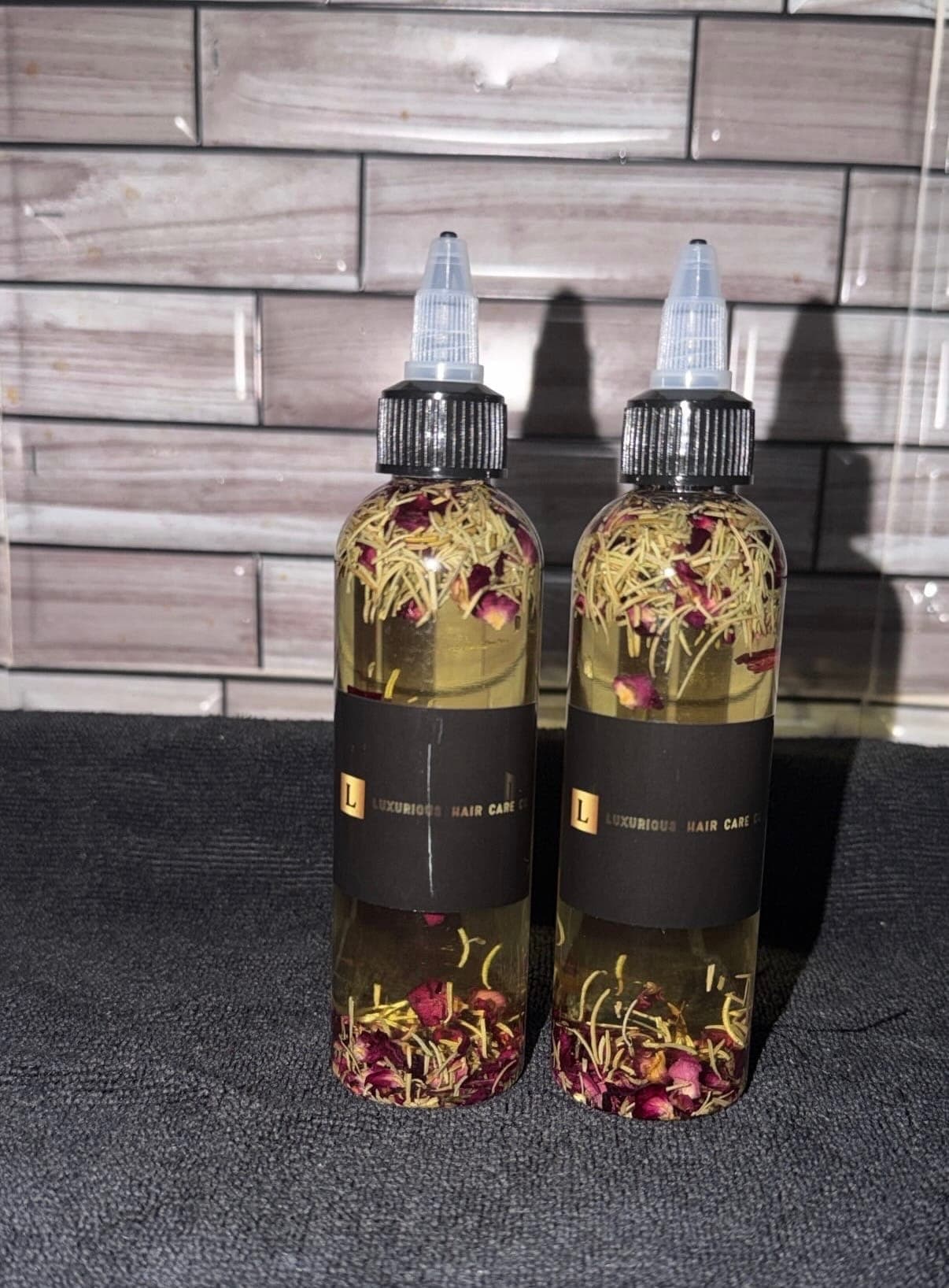 Luxurious Hair Care Co. Growth Oil bottles with herbal botanicals